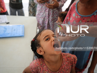 A Palestinian child receives a polio vaccination in the UK-MED field hospital in Zawayda, Gaza Strip, on September 2, 2024, amid the ongoing...