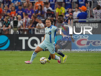 Cincinnati midfielder Obinna Nwobodo and Montreal midfielder Samuel Piette compete for the ball during the Major League Soccer match between...