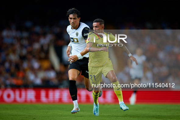 Yeremy Pino (R) of Villarreal CF runs next to Jesus Vazquez of Valencia CF during the LaLiga EA Sports match between Valencia CF and Villarr...