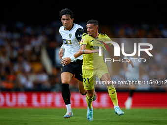 Yeremy Pino (R) of Villarreal CF runs next to Jesus Vazquez of Valencia CF during the LaLiga EA Sports match between Valencia CF and Villarr...