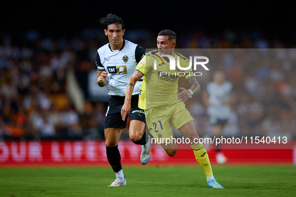 Yeremy Pino (R) of Villarreal CF runs next to Jesus Vazquez of Valencia CF during the LaLiga EA Sports match between Valencia CF and Villarr...