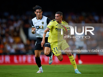 Yeremy Pino (R) of Villarreal CF runs next to Jesus Vazquez of Valencia CF during the LaLiga EA Sports match between Valencia CF and Villarr...