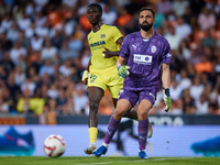 Giorgi Mamardashvili of Valencia CF is in action next to Thierno Barry of Villarreal CF during the LaLiga EA Sports match between Valencia C...