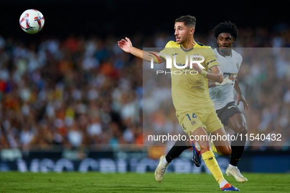 Santi Comesana Veiga of Villarreal CF competes for the ball with Thierry Rendall of Valencia CF during the LaLiga EA Sports match between Va...