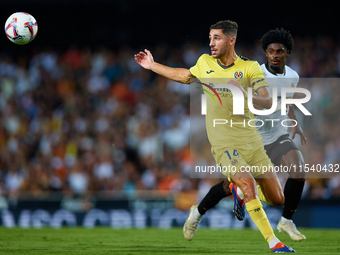 Santi Comesana Veiga of Villarreal CF competes for the ball with Thierry Rendall of Valencia CF during the LaLiga EA Sports match between Va...