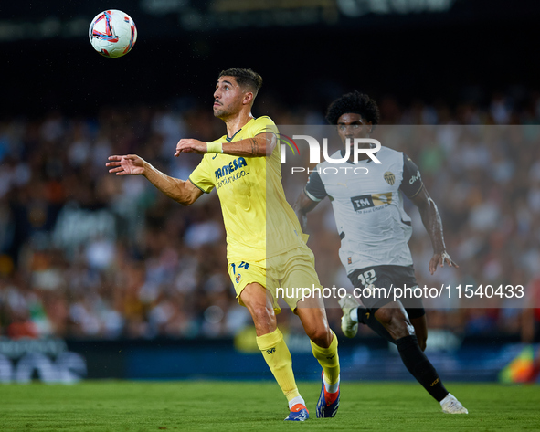 Santi Comesana Veiga of Villarreal CF competes for the ball with Thierry Rendall of Valencia CF during the LaLiga EA Sports match between Va...