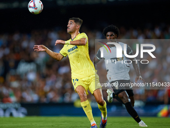 Santi Comesana Veiga of Villarreal CF competes for the ball with Thierry Rendall of Valencia CF during the LaLiga EA Sports match between Va...