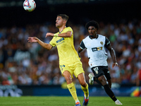 Santi Comesana Veiga of Villarreal CF competes for the ball with Thierry Rendall of Valencia CF during the LaLiga EA Sports match between Va...