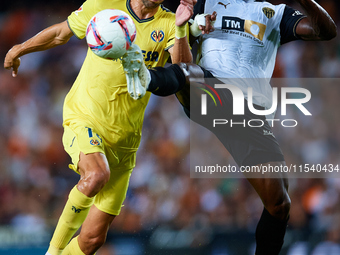 Santi Comesana Veiga of Villarreal CF competes for the ball with Thierry Rendall of Valencia CF during the LaLiga EA Sports match between Va...