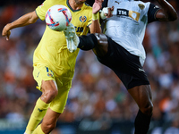 Santi Comesana Veiga of Villarreal CF competes for the ball with Thierry Rendall of Valencia CF during the LaLiga EA Sports match between Va...