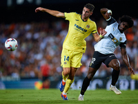 Santi Comesana Veiga of Villarreal CF competes for the ball with Thierry Rendall of Valencia CF during the LaLiga EA Sports match between Va...