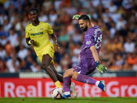 Giorgi Mamardashvili of Valencia CF competes for the ball with Thierno Barry of Villarreal CF during the LaLiga EA Sports match between Vale...