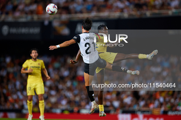 Thierno Barry of Villarreal CF competes for the ball with Jesus Vazquez of Valencia CF during the LaLiga EA Sports match between Valencia CF...