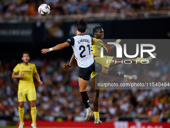 Thierno Barry of Villarreal CF competes for the ball with Jesus Vazquez of Valencia CF during the LaLiga EA Sports match between Valencia CF...