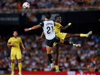 Thierno Barry of Villarreal CF competes for the ball with Jesus Vazquez of Valencia CF during the LaLiga EA Sports match between Valencia CF...