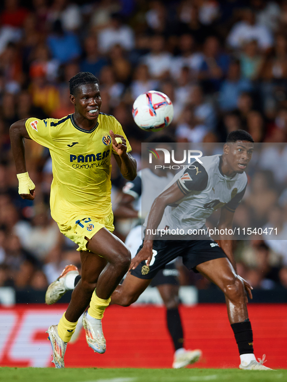 Thierno Barry of Villarreal CF competes for the ball with Cristhian Mosquera of Valencia CF during the LaLiga EA Sports match between Valenc...