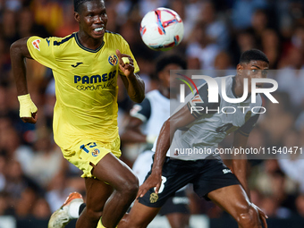 Thierno Barry of Villarreal CF competes for the ball with Cristhian Mosquera of Valencia CF during the LaLiga EA Sports match between Valenc...