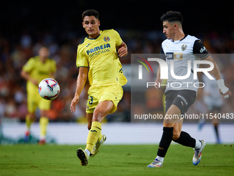 Sergi Cardona of Villarreal CF competes for the ball with Diego Lopez of Valencia CF during the LaLiga EA Sports match between Valencia CF a...