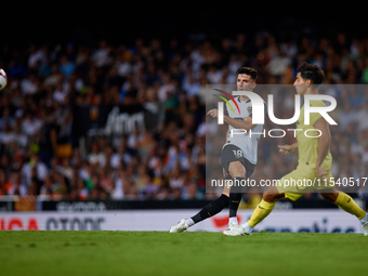 Pepelu (L) of Valencia CF competes for the ball with Ramon Terrats of Villarreal CF during the LaLiga EA Sports match between Valencia CF an...