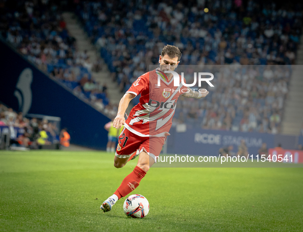 Rayo Vallecano forward takes a powerful shot on goal during the match against Espanyol. 