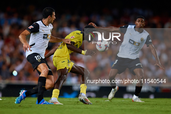 Thierno Barry of Villarreal CF competes for the ball with Cesar Tarrega of Valencia CF during the LaLiga EA Sports match between Valencia CF...