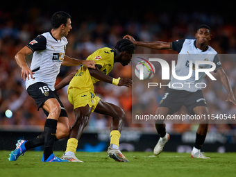 Thierno Barry of Villarreal CF competes for the ball with Cesar Tarrega of Valencia CF during the LaLiga EA Sports match between Valencia CF...