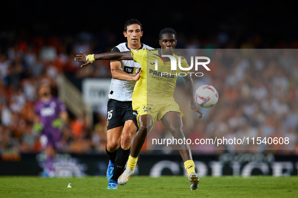 Thierno Barry of Villarreal CF competes for the ball with Cesar Tarrega of Valencia CF during the LaLiga EA Sports match between Valencia CF...