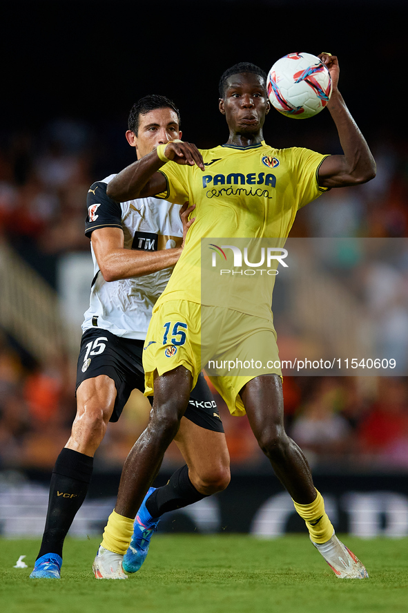 Thierno Barry of Villarreal CF competes for the ball with Cesar Tarrega of Valencia CF during the LaLiga EA Sports match between Valencia CF...