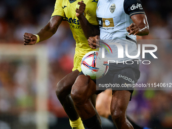 Dimitri Foulquier (R) of Valencia CF competes for the ball with Thierno Barry of Villarreal CF during the LaLiga EA Sports match between Val...