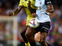 Dimitri Foulquier (R) of Valencia CF competes for the ball with Thierno Barry of Villarreal CF during the LaLiga EA Sports match between Val...