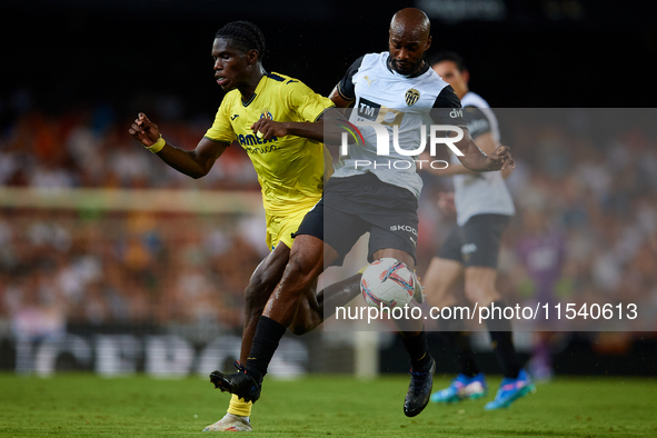 Dimitri Foulquier (R) of Valencia CF competes for the ball with Thierno Barry of Villarreal CF during the LaLiga EA Sports match between Val...