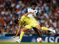 Ramon Terrats of Villarreal CF competes for the ball with Thierry Rendall of Valencia CF during the LaLiga EA Sports match between Valencia...