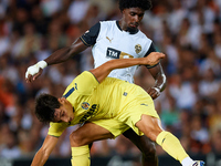 Ramon Terrats of Villarreal CF competes for the ball with Thierry Rendall of Valencia CF during the LaLiga EA Sports match between Valencia...