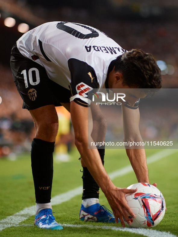 Andre Almeida of Valencia CF sets the ball on the corner spot during the LaLiga EA Sports match between Valencia CF and Villarreal CF at Mes...