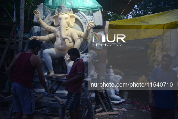 Artisans work on idols of the elephant-headed Hindu deity Ganesha at Kumartuli (artisan workshop) ahead of the Ganesh Chaturthi festival in...