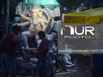 Artisans work on idols of the elephant-headed Hindu deity Ganesha at Kumartuli (artisan workshop) ahead of the Ganesh Chaturthi festival in...