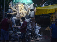 Artisans work on idols of the elephant-headed Hindu deity Ganesha at Kumartuli (artisan workshop) ahead of the Ganesh Chaturthi festival in...