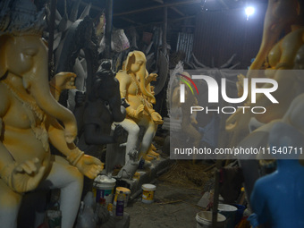 Artisans work on idols of the elephant-headed Hindu deity Ganesha at Kumartuli (artisan workshop) ahead of the Ganesh Chaturthi festival in...