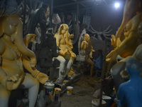 Artisans work on idols of the elephant-headed Hindu deity Ganesha at Kumartuli (artisan workshop) ahead of the Ganesh Chaturthi festival in...