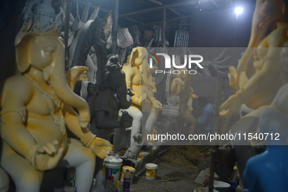 Artisans work on idols of the elephant-headed Hindu deity Ganesha at Kumartuli (artisan workshop) ahead of the Ganesh Chaturthi festival in...