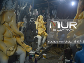 Artisans work on idols of the elephant-headed Hindu deity Ganesha at Kumartuli (artisan workshop) ahead of the Ganesh Chaturthi festival in...