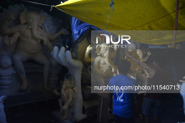 Artisans work on idols of the elephant-headed Hindu deity Ganesha at Kumartuli (artisan workshop) ahead of the Ganesh Chaturthi festival in...