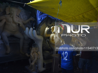 Artisans work on idols of the elephant-headed Hindu deity Ganesha at Kumartuli (artisan workshop) ahead of the Ganesh Chaturthi festival in...