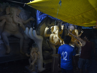 Artisans work on idols of the elephant-headed Hindu deity Ganesha at Kumartuli (artisan workshop) ahead of the Ganesh Chaturthi festival in...