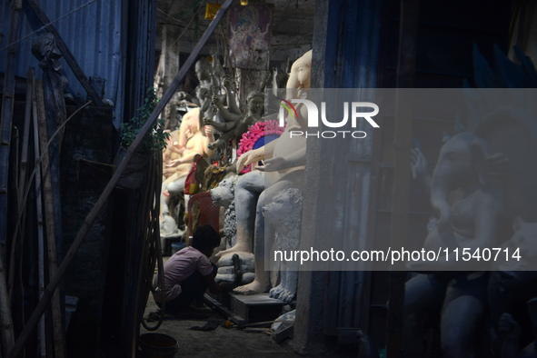 Artisans work on idols of the elephant-headed Hindu deity Ganesha at Kumartuli (artisan workshop) ahead of the Ganesh Chaturthi festival in...