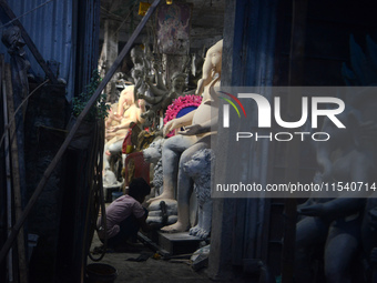 Artisans work on idols of the elephant-headed Hindu deity Ganesha at Kumartuli (artisan workshop) ahead of the Ganesh Chaturthi festival in...