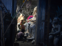 Artisans work on idols of the elephant-headed Hindu deity Ganesha at Kumartuli (artisan workshop) ahead of the Ganesh Chaturthi festival in...