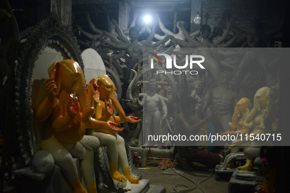 Artisans work on idols of the elephant-headed Hindu deity Ganesha at Kumartuli (artisan workshop) ahead of the Ganesh Chaturthi festival in...