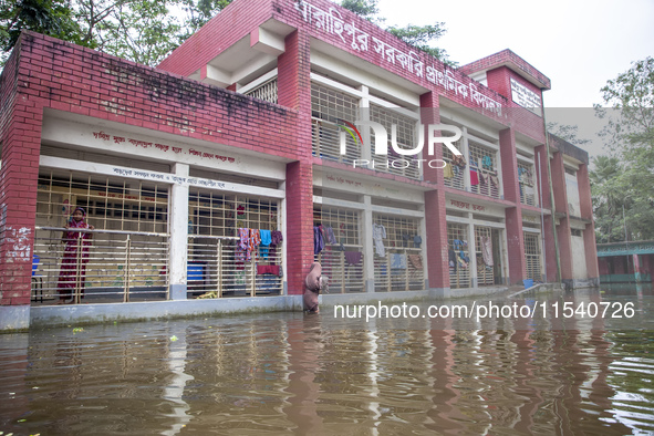 A few families take shelter in a school for 10 days after being affected by flood water in a village of Sonapur Union of Sonaimuri Upazila o...