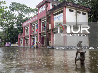 A few families take shelter in a school for 10 days after being affected by flood water in a village of Sonapur Union of Sonaimuri Upazila o...